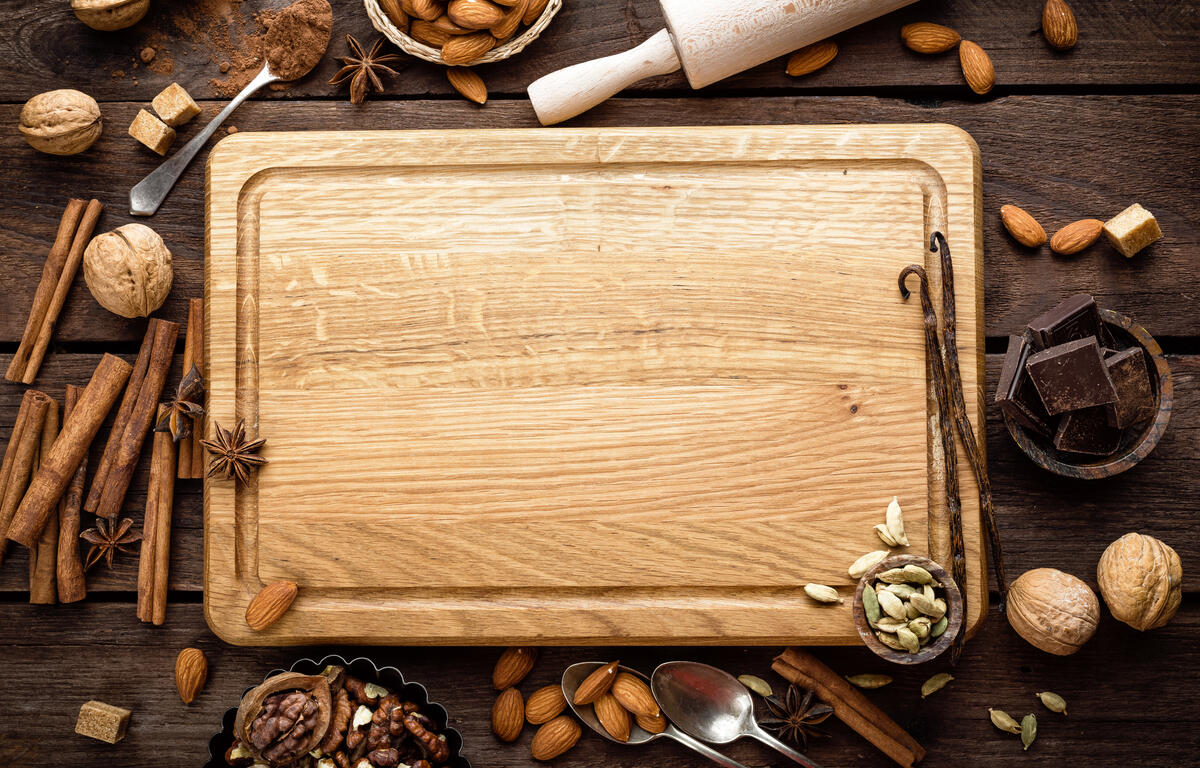 cutting board with various baking items around it.