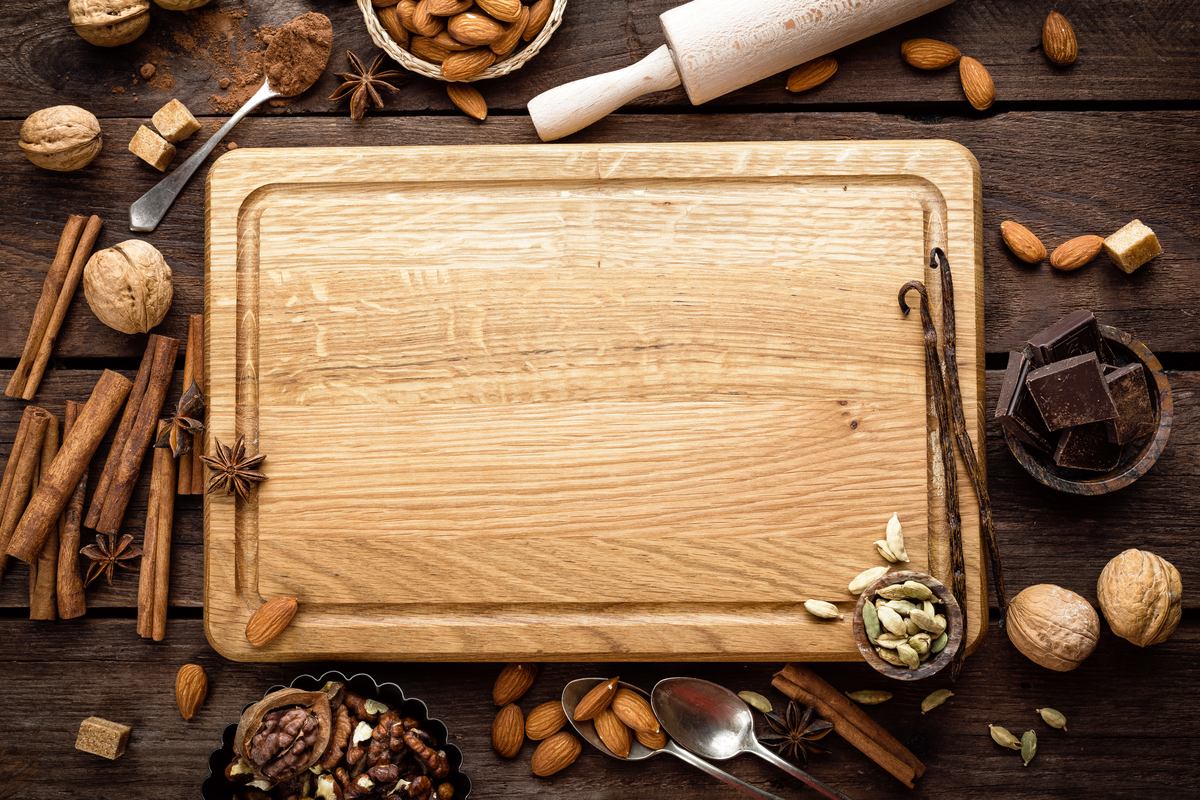 cutting board with various baking items around it.