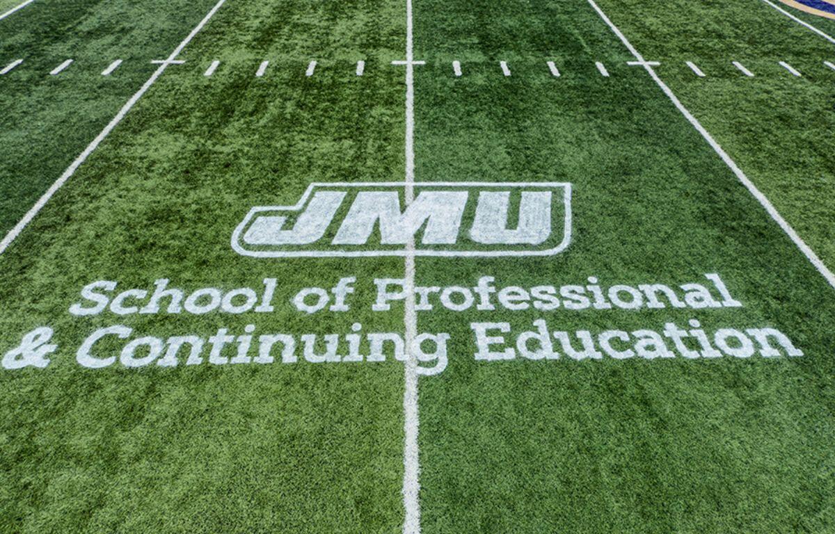 JMU School of Professional and Continuing Education logo displayed on Bridgeforth playing field