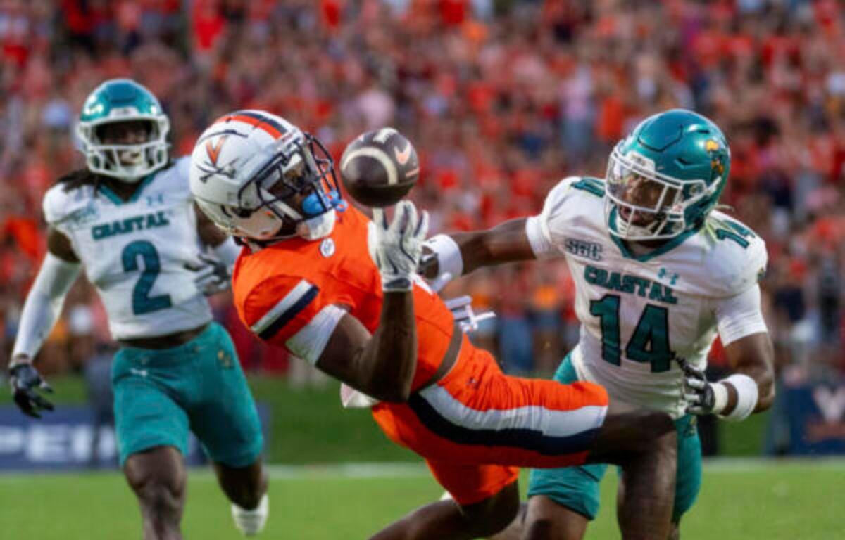 Virginia Cavaliers wide receiver Cam Ross (6) makes a great catch defended by Coastal Carolina Chanticleers safety Myles Woods (14) during the first half of an NCAA college football game, Saturday, Aug. 30, 2025, in Charlottesville, Va. (AP Photo/Robert Simmons)