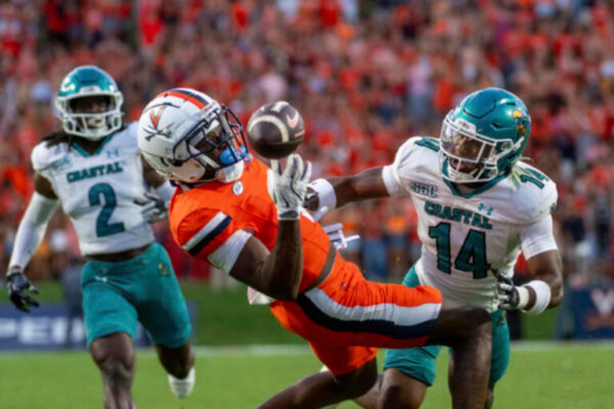 Virginia Cavaliers wide receiver Cam Ross (6) makes a great catch defended by Coastal Carolina Chanticleers safety Myles Woods (14) during the first half of an NCAA college football game, Saturday, Aug. 30, 2025, in Charlottesville, Va. (AP Photo/Robert Simmons)