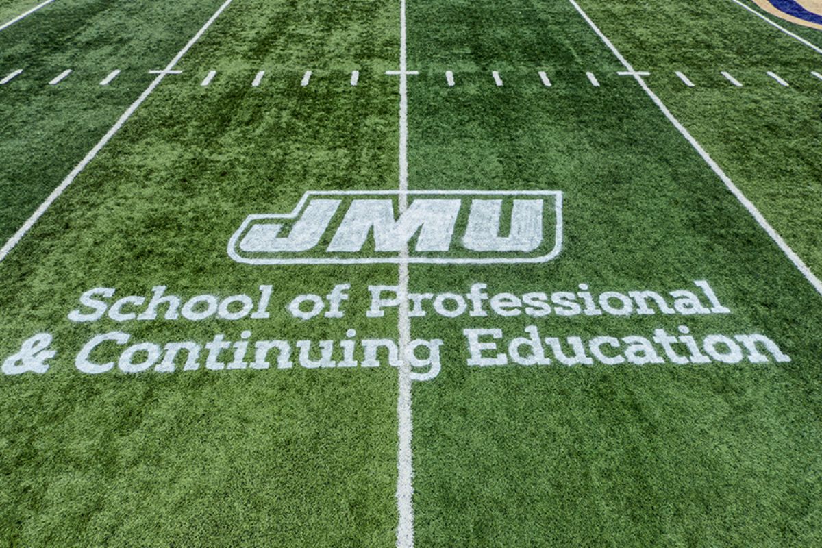 JMU School of Professional and Continuing Education logo displayed on Bridgeforth playing field