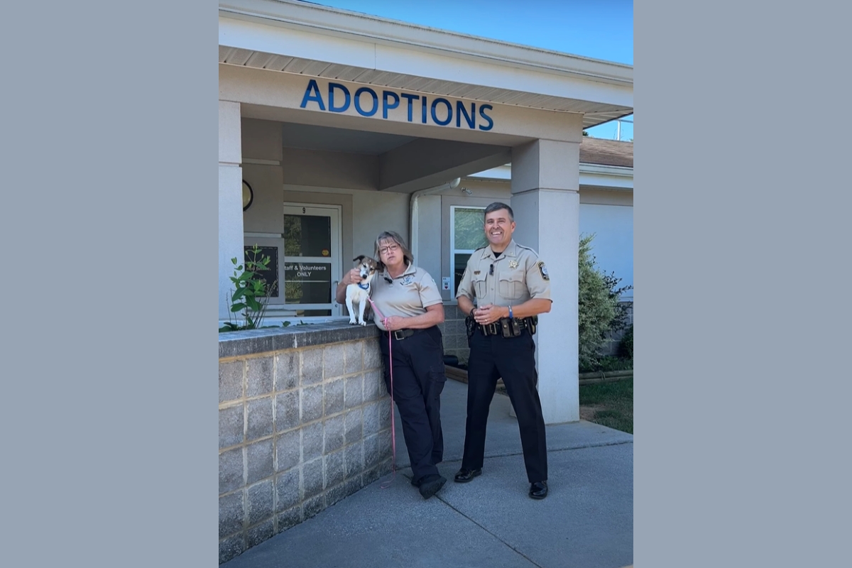 Sheriff Bryan Hutcheson with a dog in front of the SPCA.