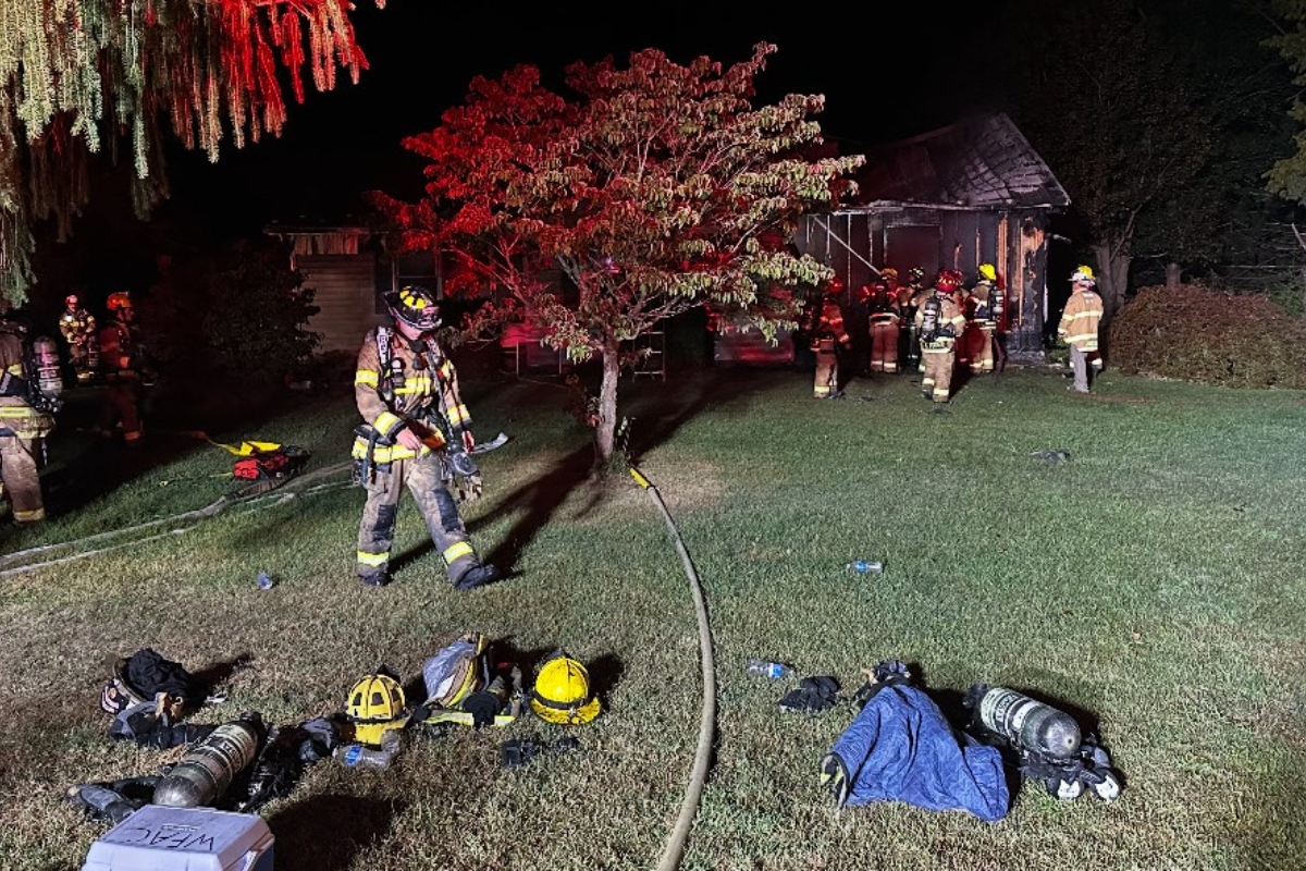 Firefighters outside of a house on fire