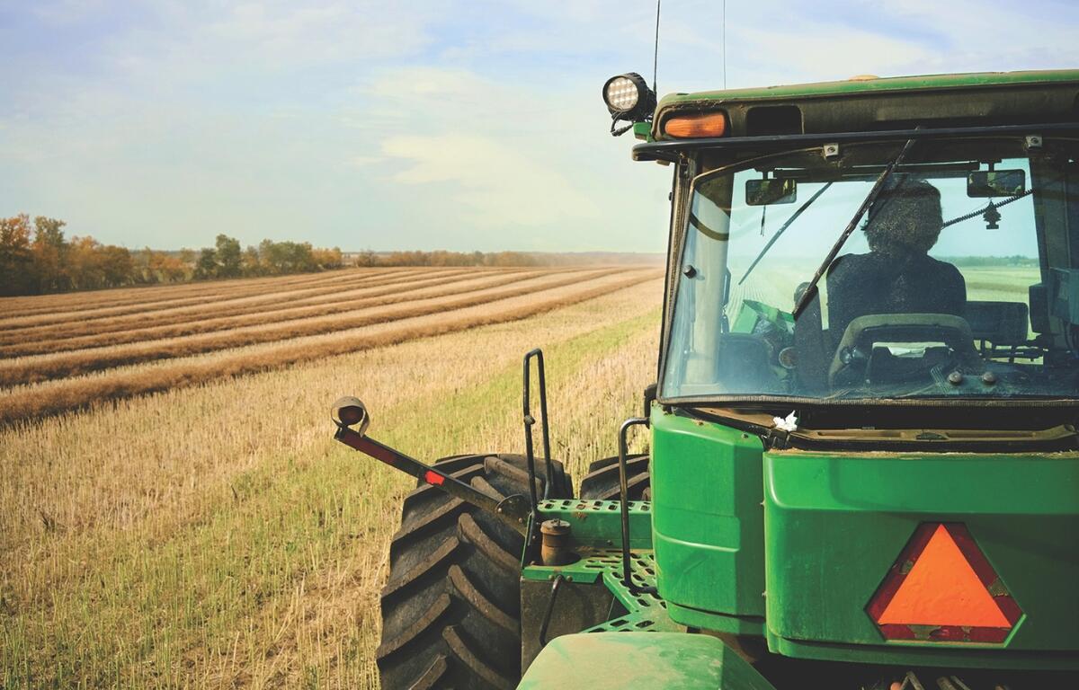 A tractor harvesting a field.
