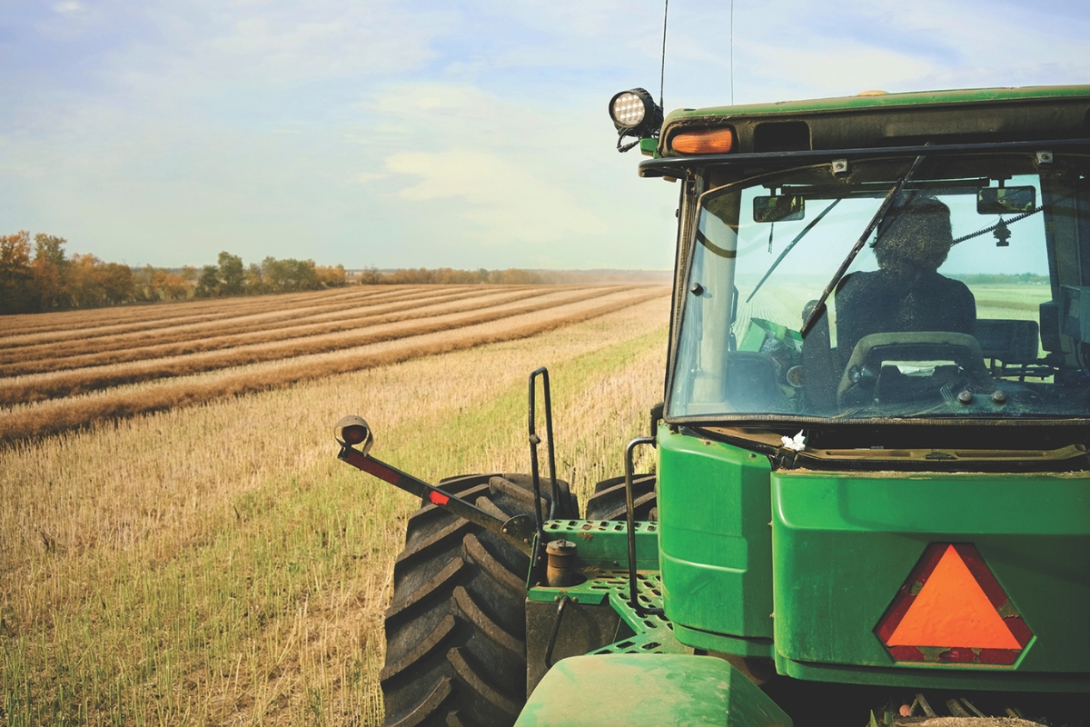 A tractor harvesting a field.