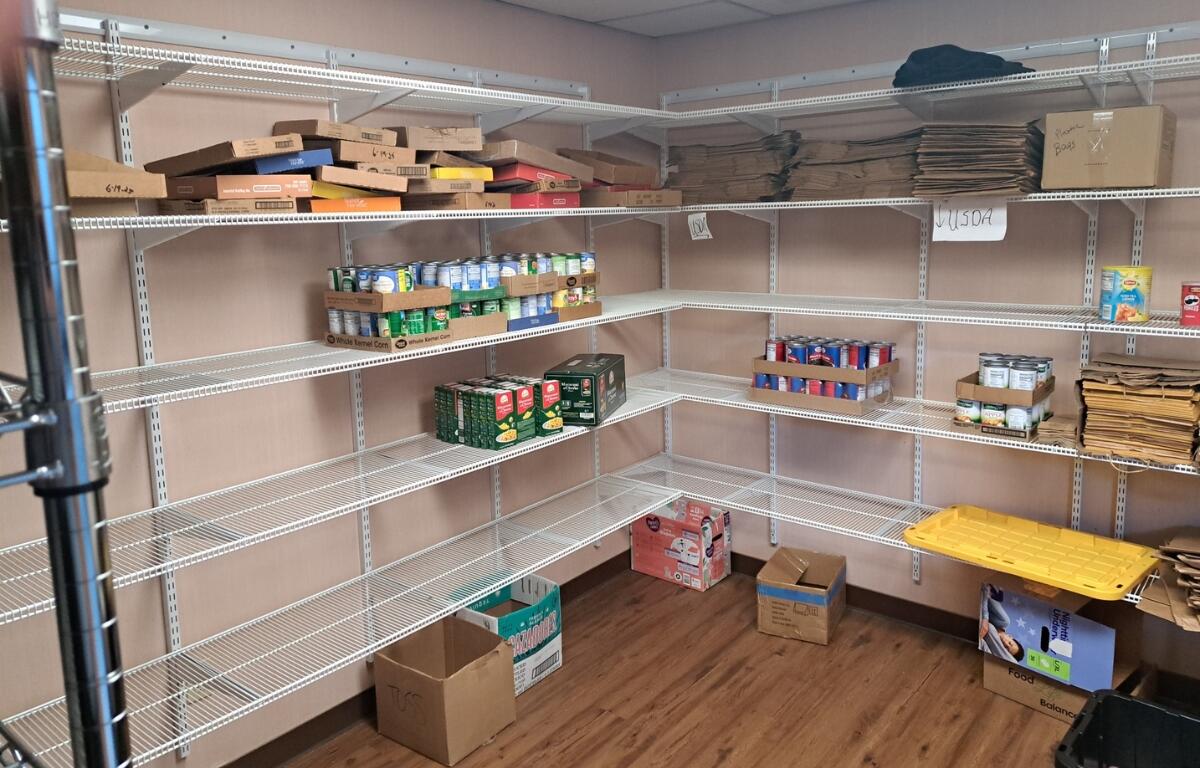 Shelves at the Salvation Army with only a few cans.