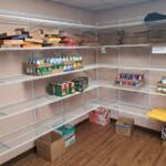 Shelves at the Salvation Army with only a few cans.
