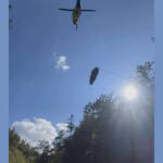 A helicopter raises the woman out of