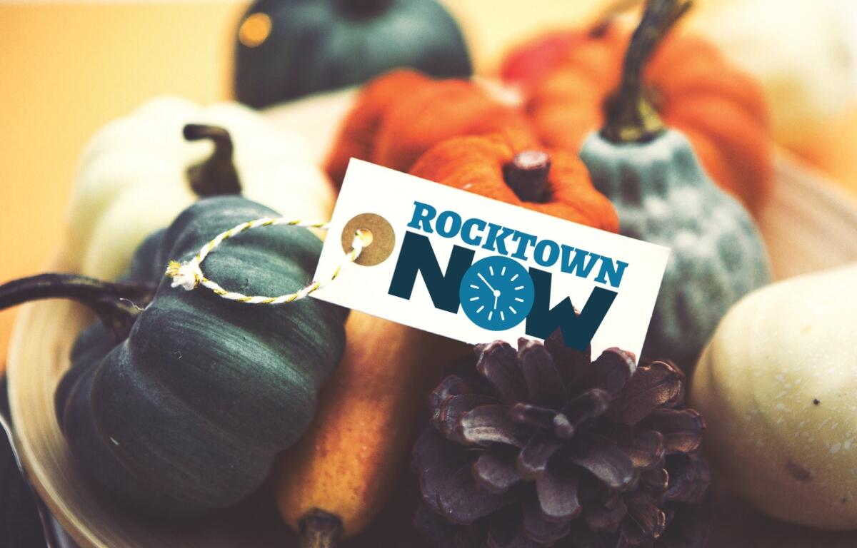 Several different colored pumpkins with a tag on top that says Rocktown Now.