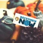 Several different colored pumpkins with a tag on top that says Rocktown Now.