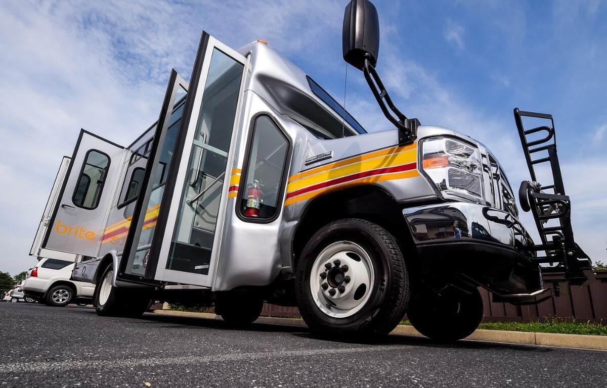A brite bus in a parking lot.