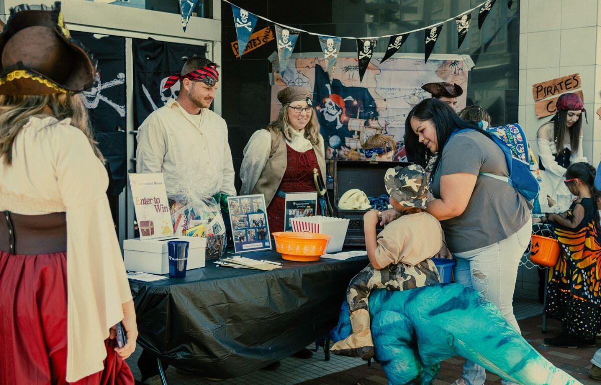 2024 Skeleton Festival attendees visiting a local downtown business for trick-or-treating