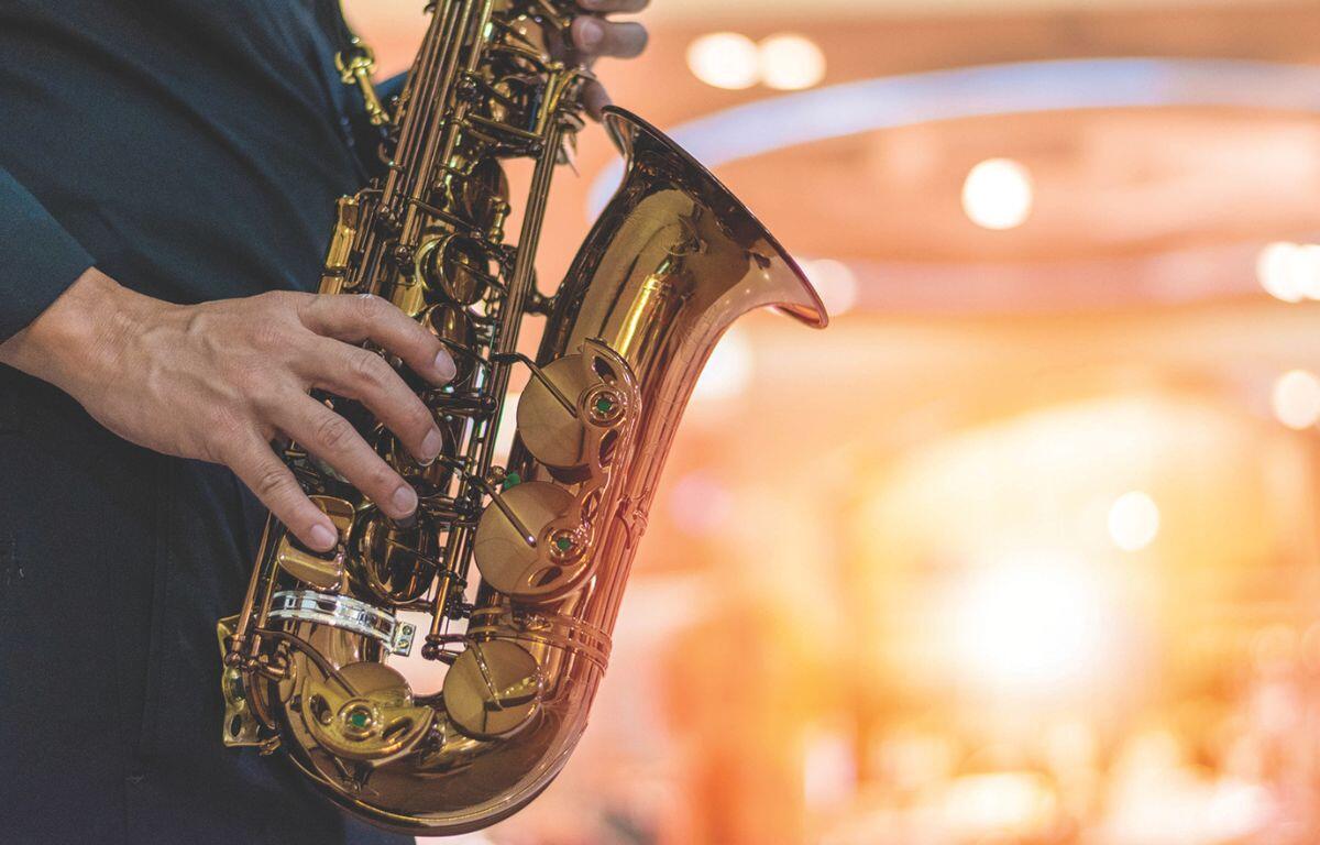 Musician playing saxophone on stage