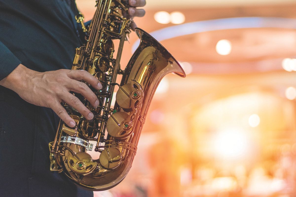 Musician playing saxophone on stage