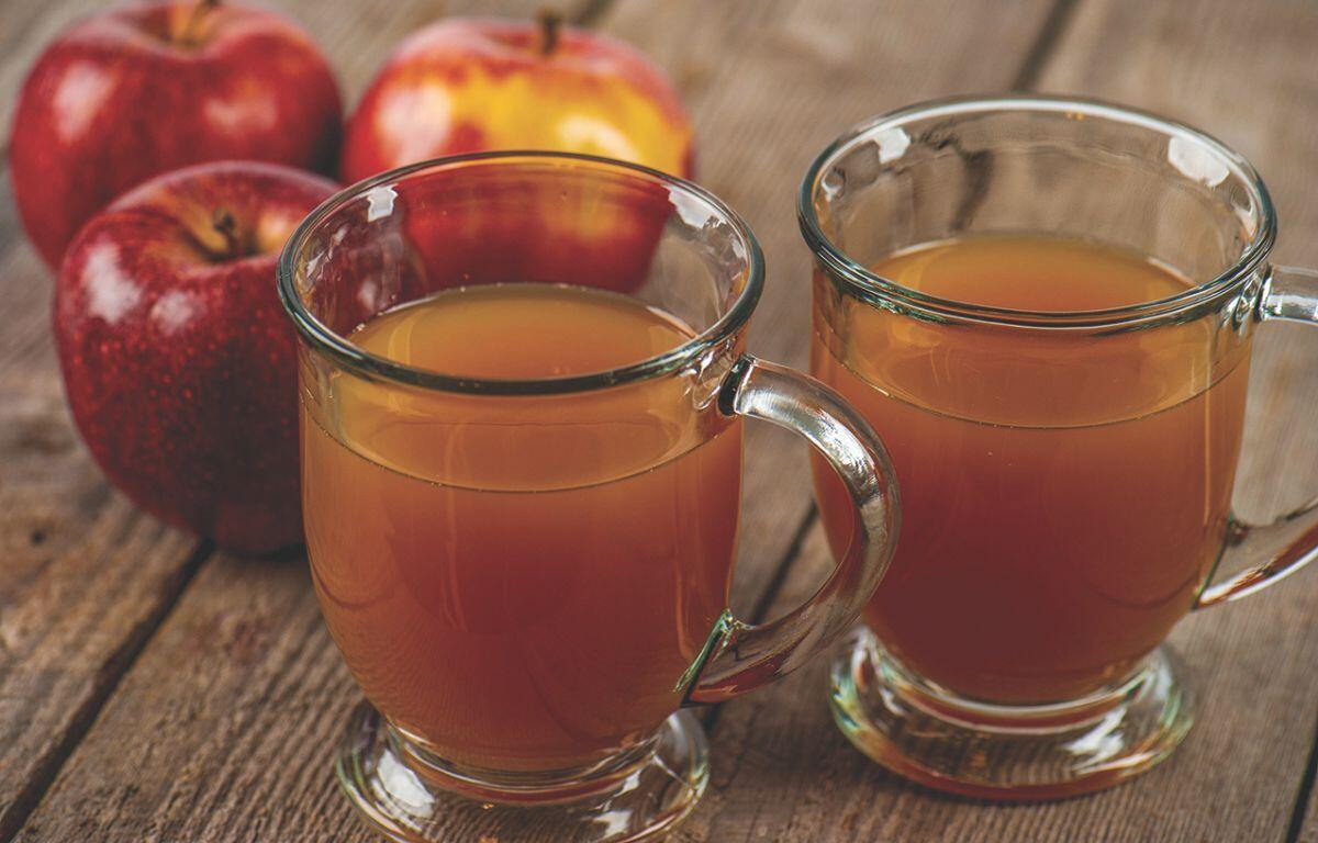 Glasses of cider with apples