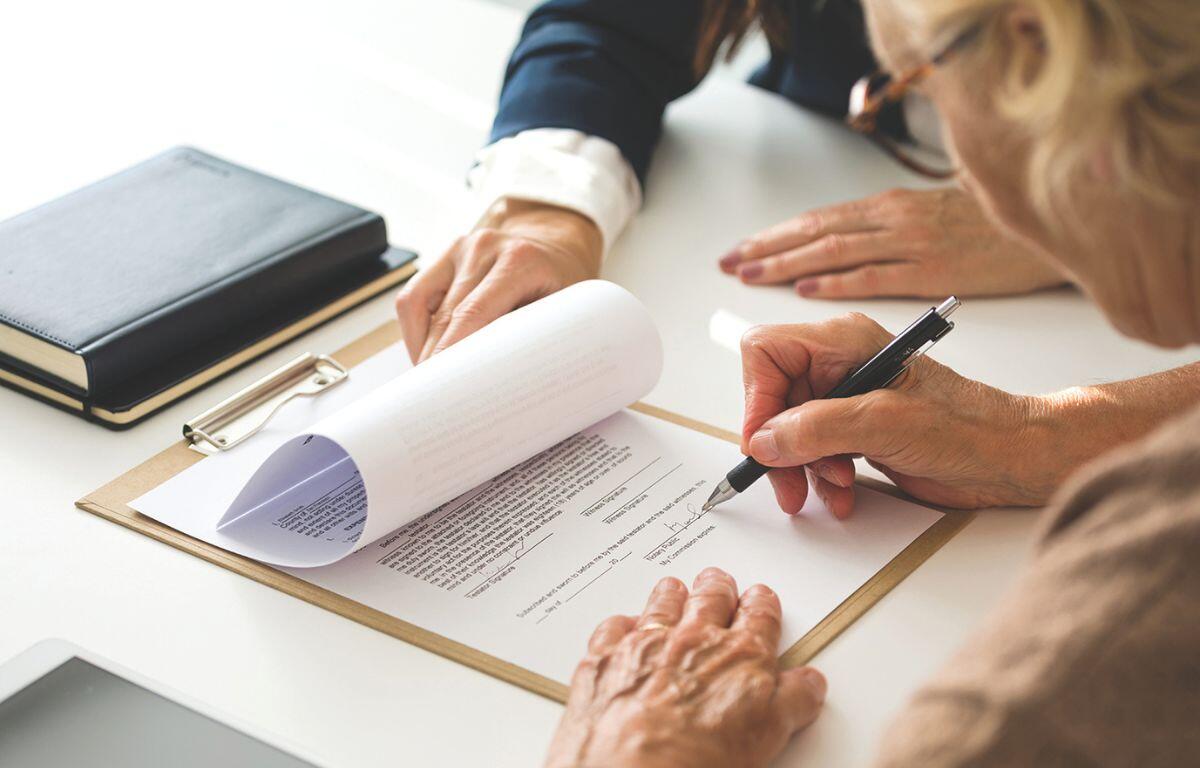 Woman signing a document