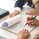 Woman signing a document