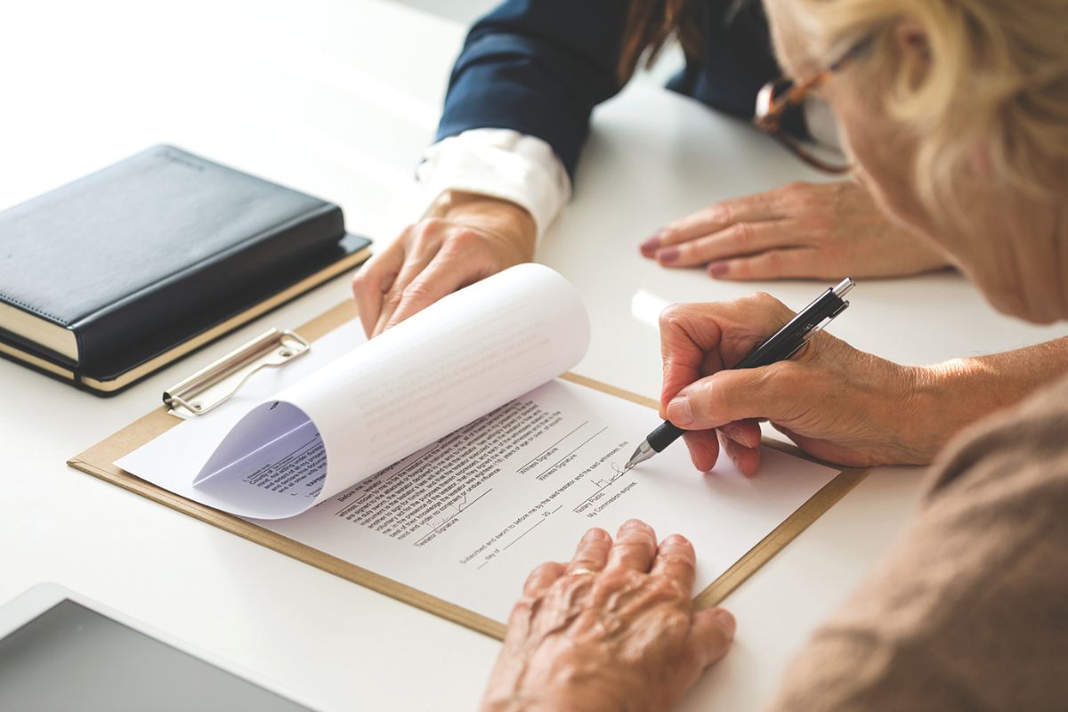 Woman signing a document