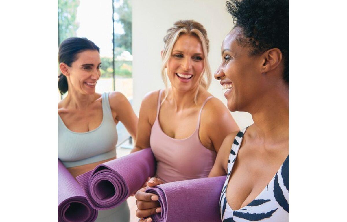 Women talking at a yoga class