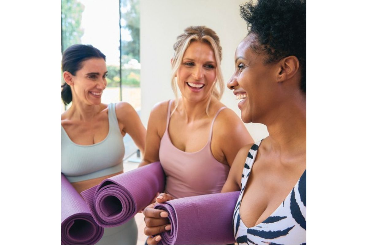 Women talking at a yoga class