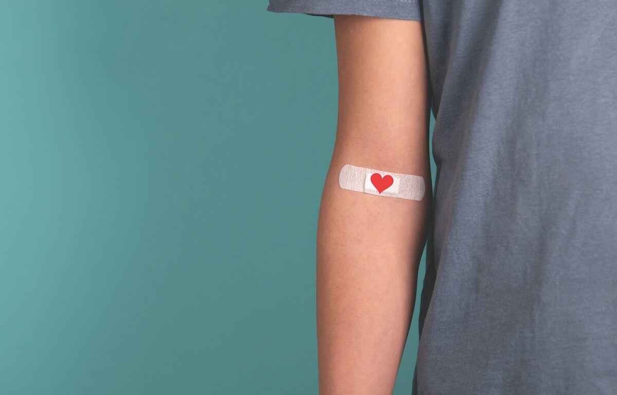 Band-Aid with a heart on it on an arm