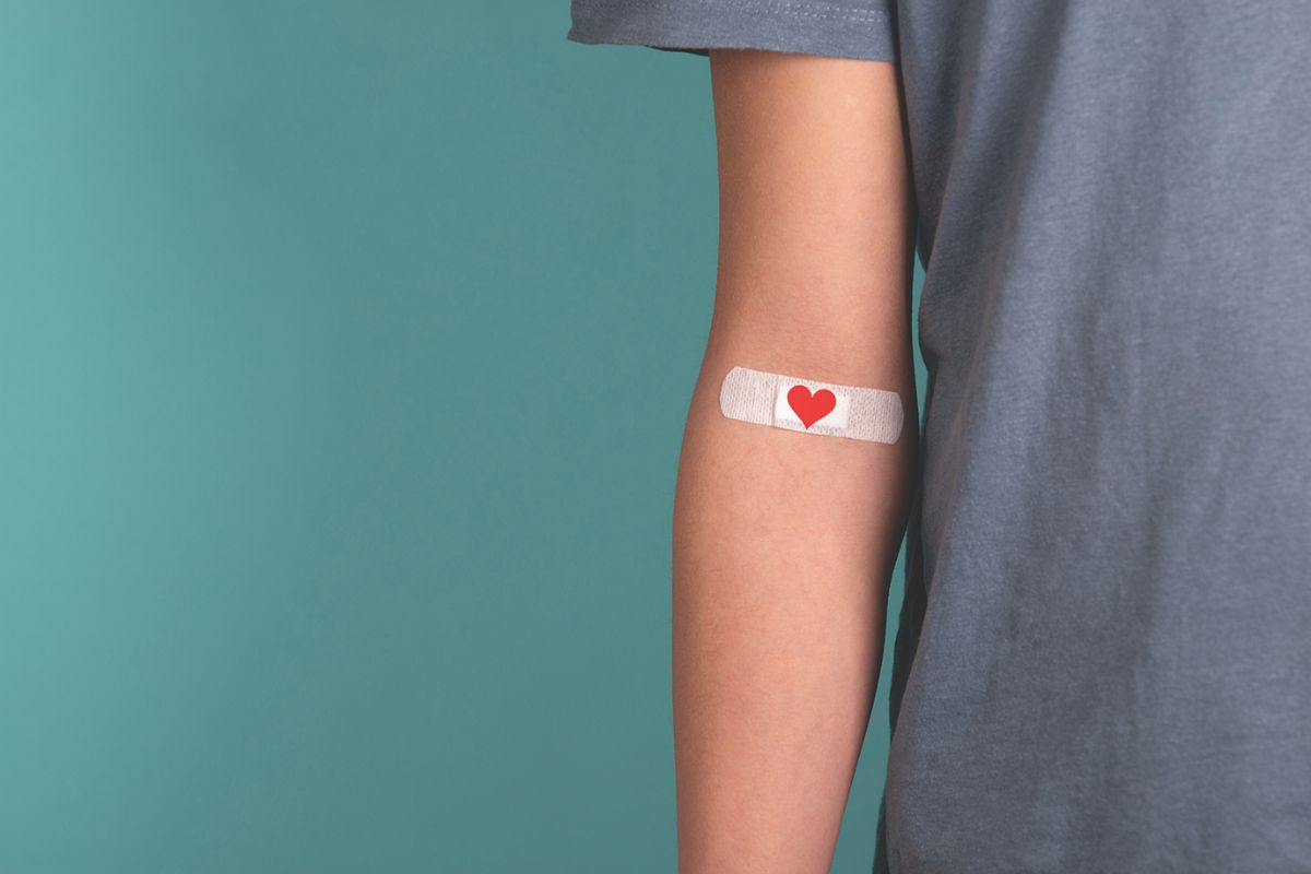 Band-Aid with a heart on it on an arm