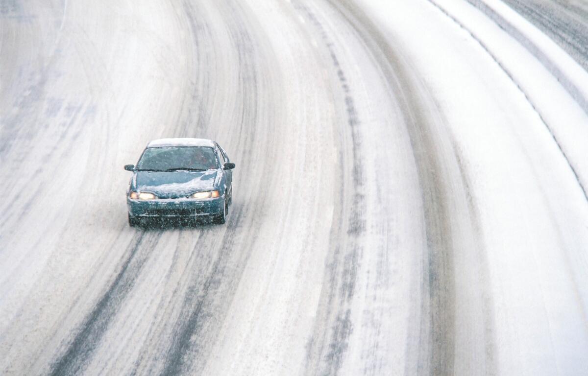 Car on snowy road.