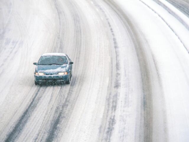 Car on snowy road.