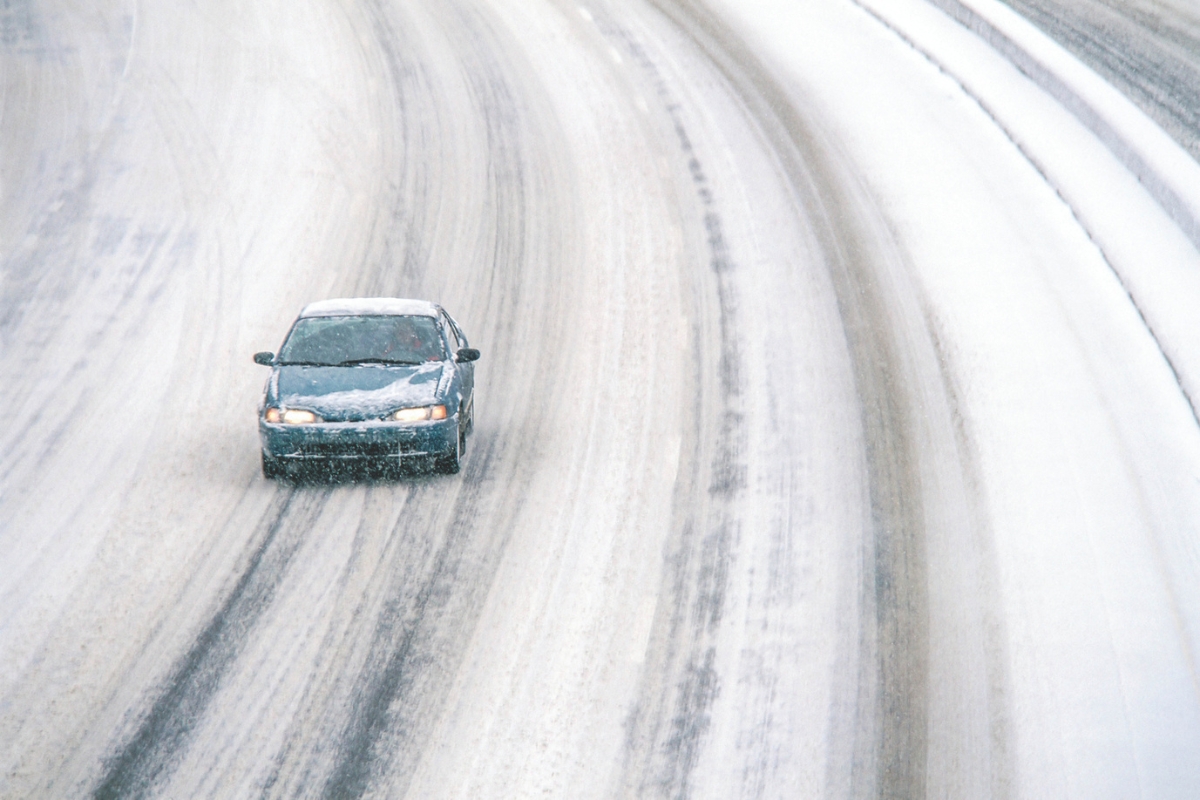 Car on snowy road.