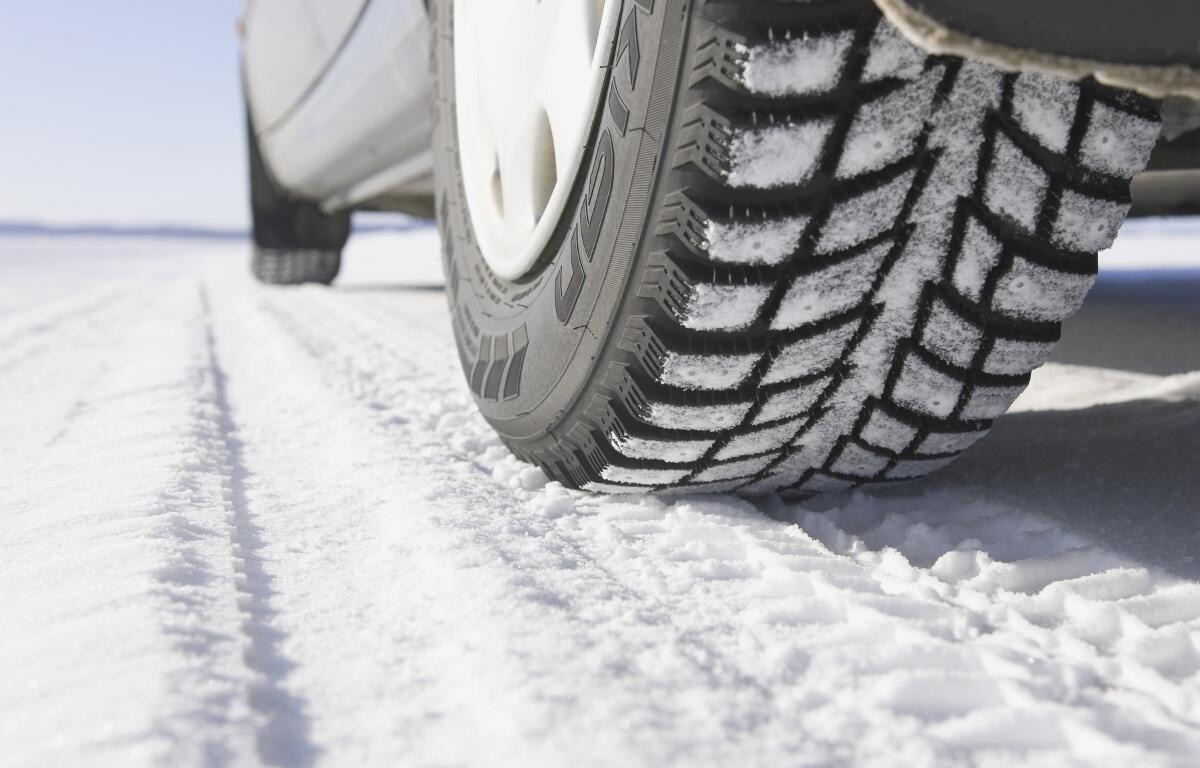 Up close of car tires on a snowy road