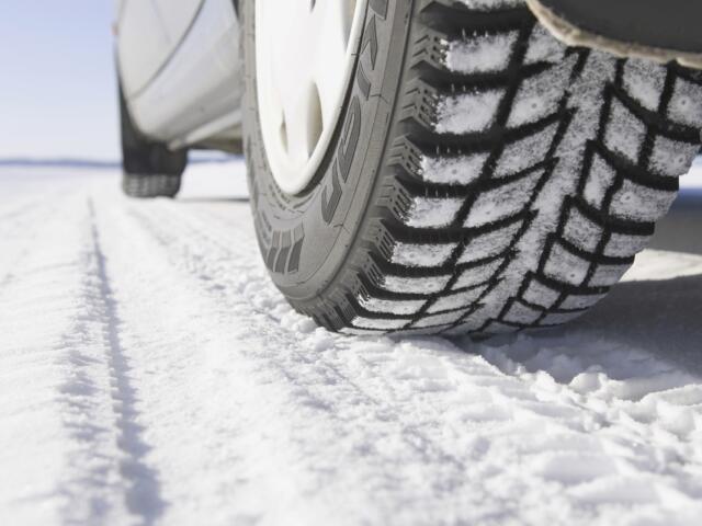 Up close of car tires on a snowy road