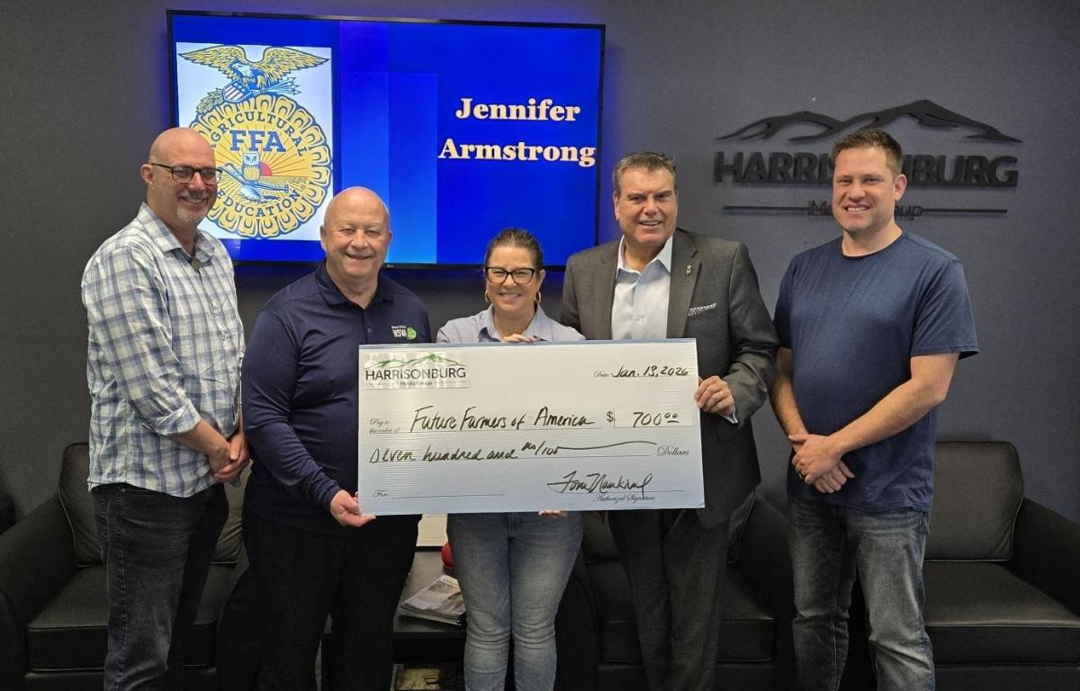 Harrisonburg Media Group and WSIG present Virginia FFA with a check.