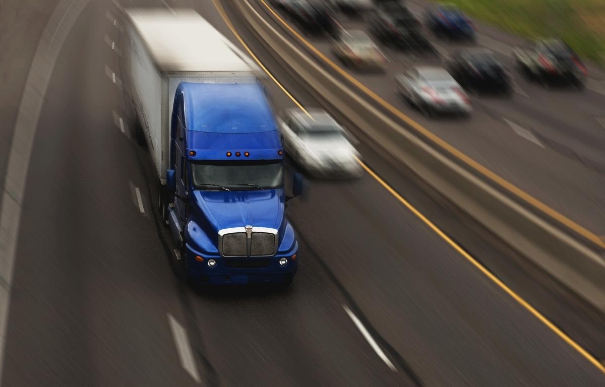 A semi truck on a busy interstate.