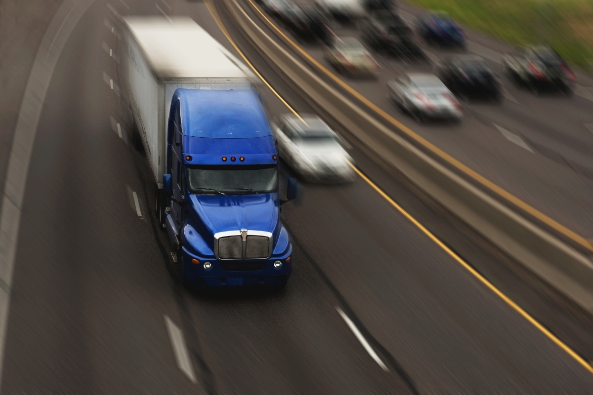 A semi truck on a busy interstate.