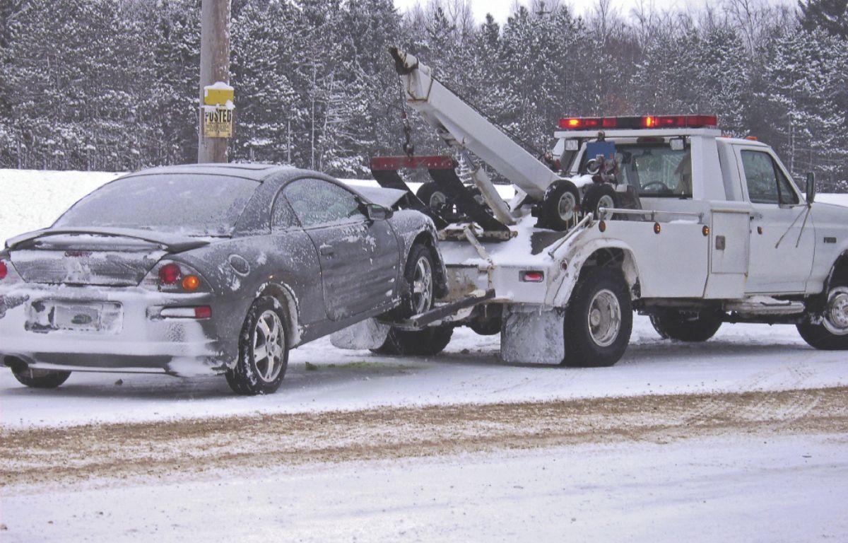 A car getting towed in snow