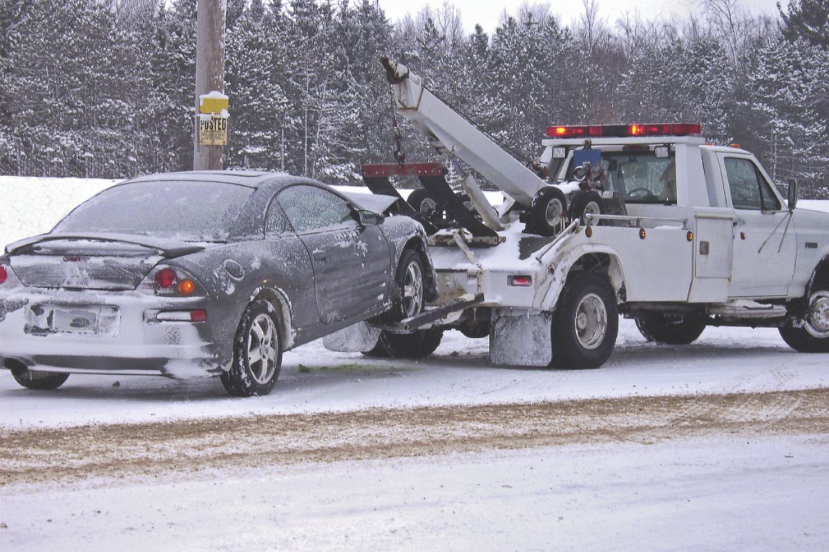 A car getting towed in snow