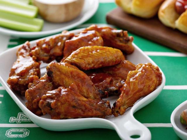 Chicken wings in a bowl on a table.