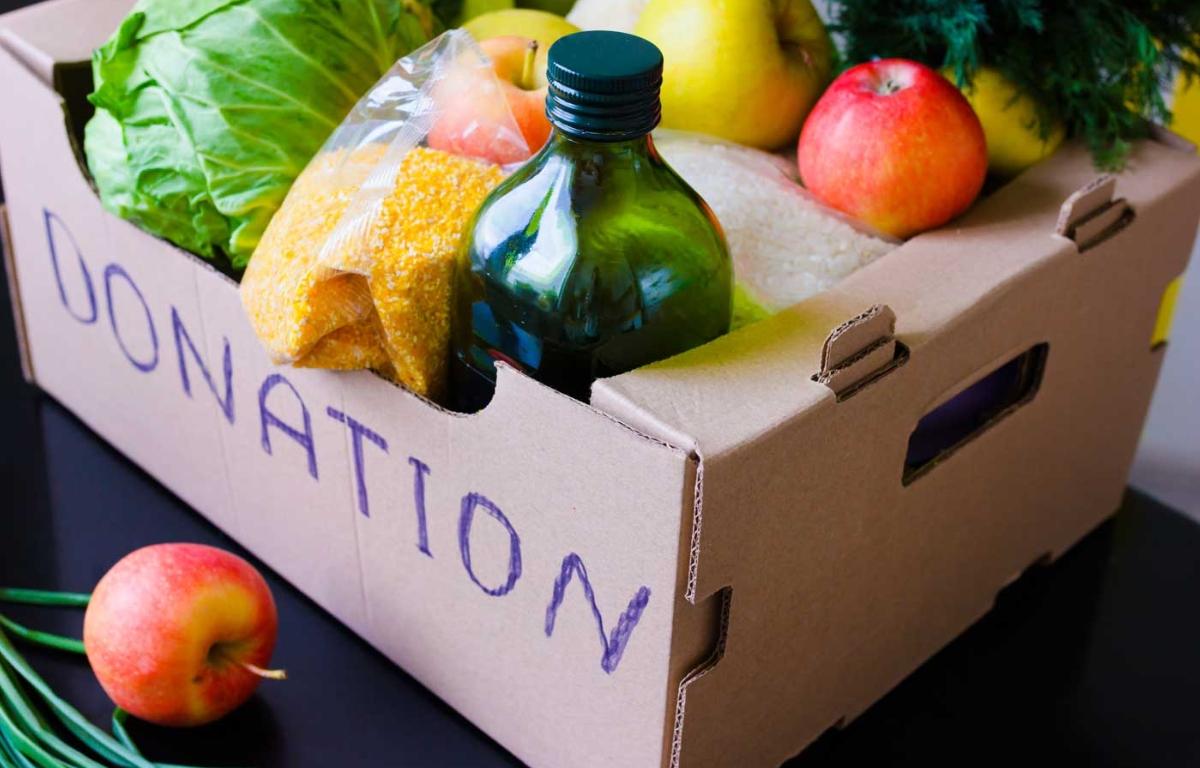 Produce in a donation box on a table.