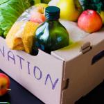 Produce in a donation box on a table.