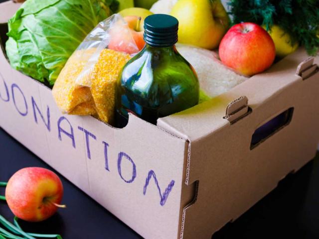 Produce in a donation box on a table.