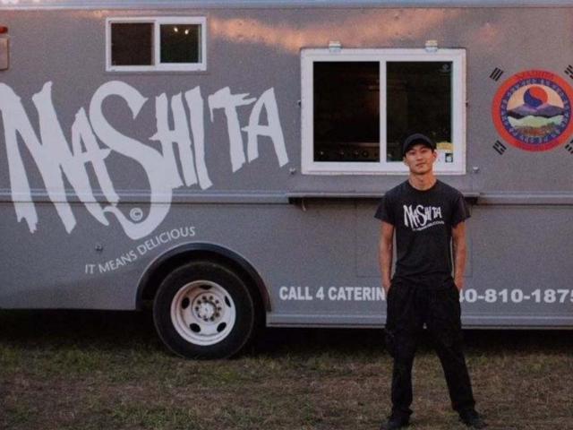 Chef Mikey Reisenberg stands beside the Mashita food truck.