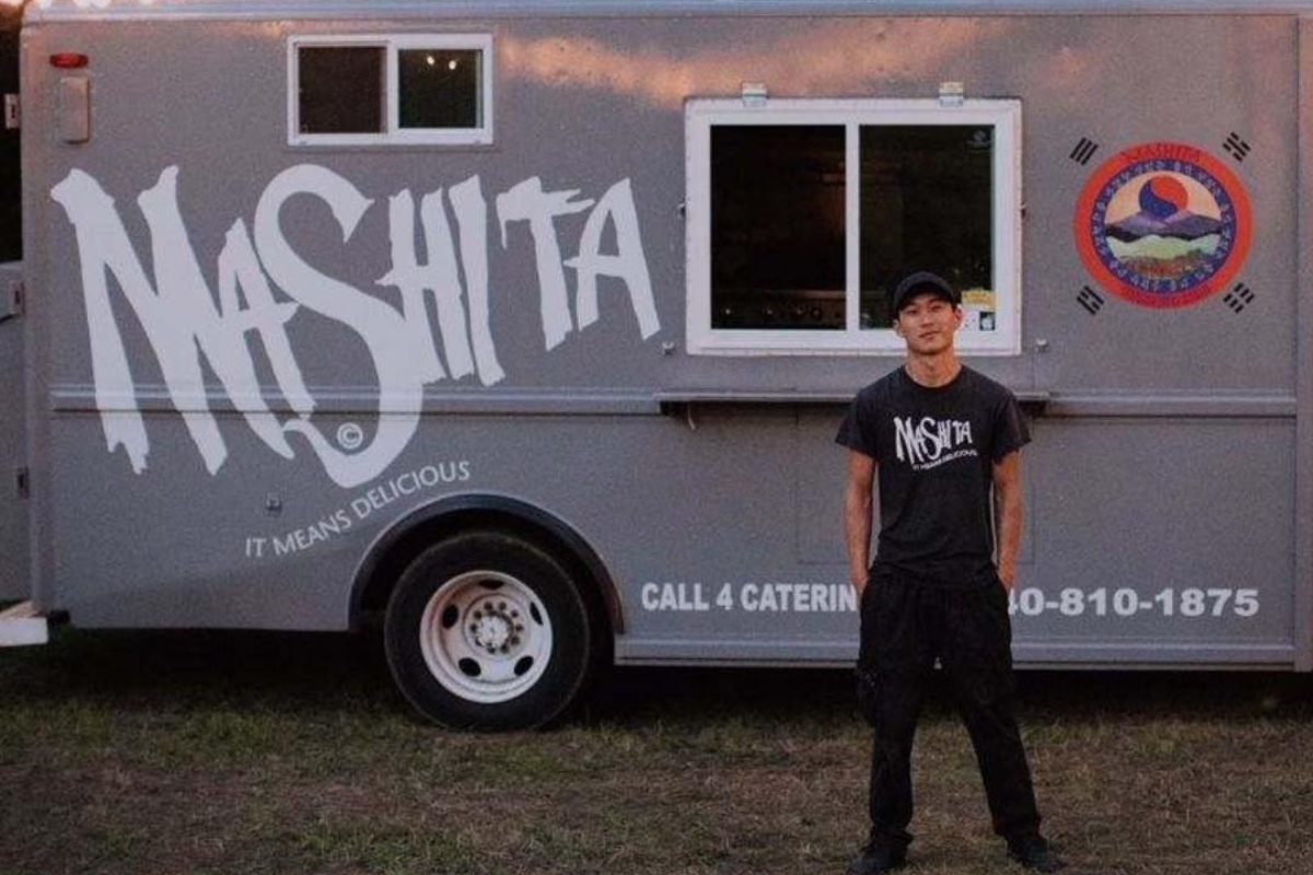 Chef Mikey Reisenberg stands beside the Mashita food truck.