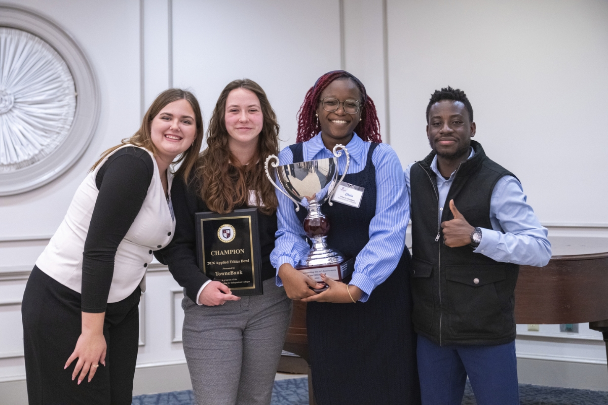 Ifeatu Udokwu, Laine Anthony, Madison Lizarraga, and Isaac Plange holding a plaque and trophy.