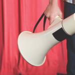 A person holding a megaphone.