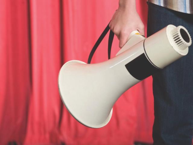 A person holding a megaphone.