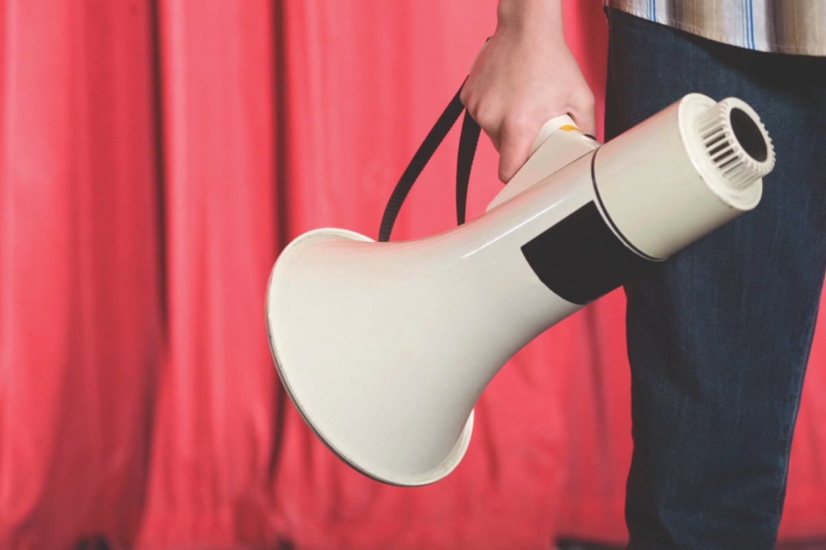 A person holding a megaphone.