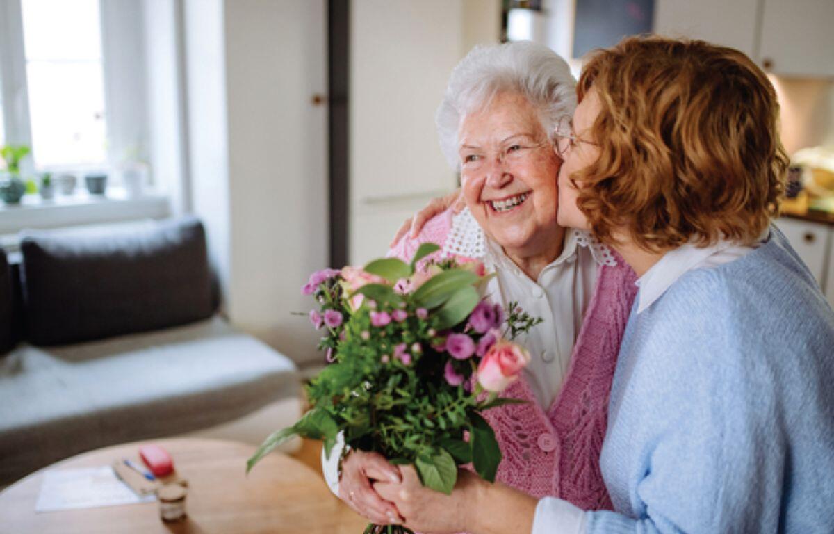 Woman giving her mother flowers