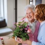 Woman giving her mother flowers