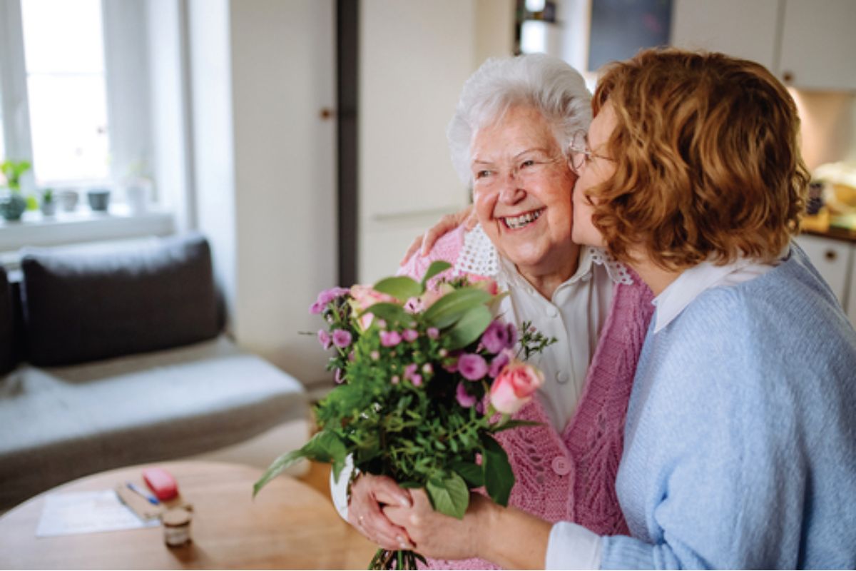 Woman giving her mother flowers